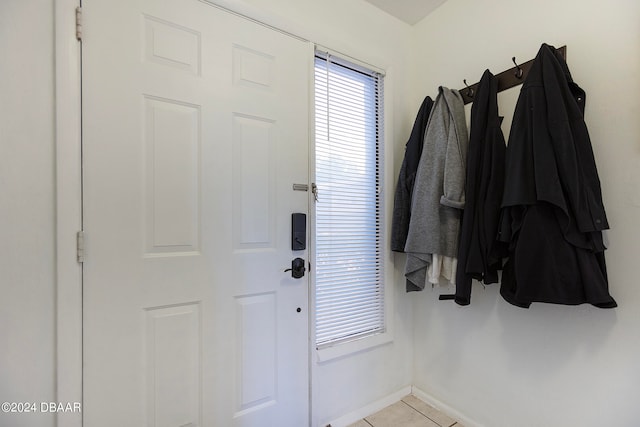 doorway to outside with light tile patterned floors