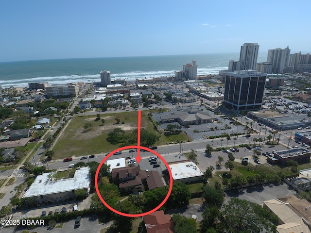drone / aerial view featuring a city view and a water view