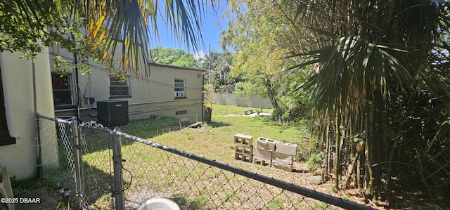 view of yard featuring central air condition unit and fence
