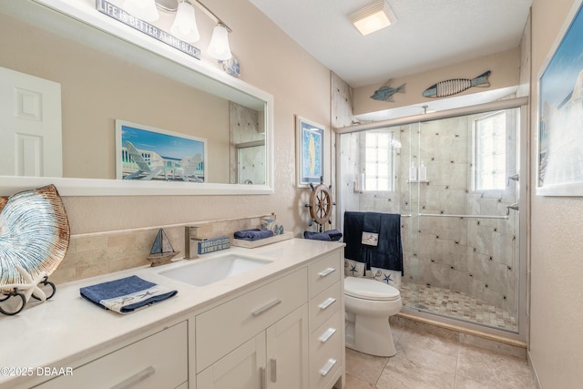 bathroom featuring vanity, toilet, and walk in shower