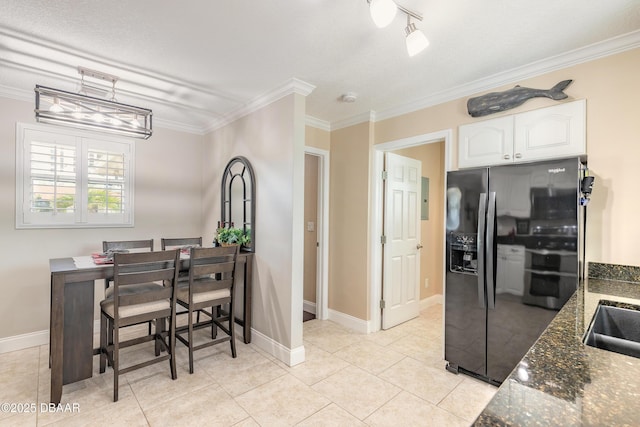 kitchen featuring ornamental molding, dark stone countertops, black fridge with ice dispenser, and white cabinets