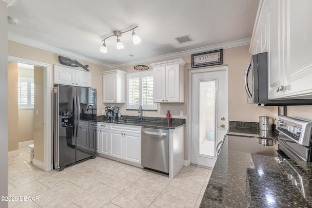 kitchen featuring sink, a textured ceiling, white cabinets, and appliances with stainless steel finishes