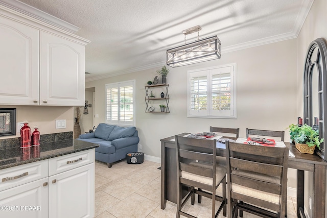 dining space with ornamental molding, light tile patterned flooring, and a textured ceiling