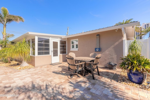 view of patio / terrace featuring a sunroom