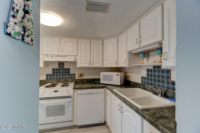 kitchen featuring white cabinetry, sink, a textured ceiling, white appliances, and decorative backsplash