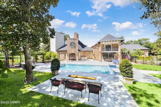 view of swimming pool featuring a yard and a patio area