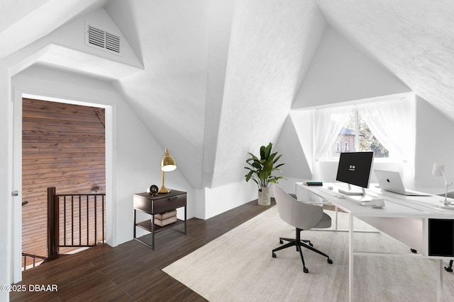 office space with vaulted ceiling and dark hardwood / wood-style floors