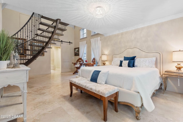 bedroom with a high ceiling and a notable chandelier