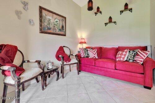 tiled living area with lofted ceiling