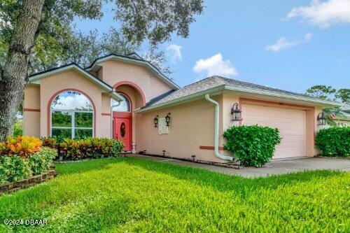 ranch-style home with a garage and a front yard