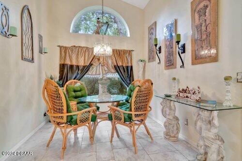 sitting room featuring baseboards and an inviting chandelier