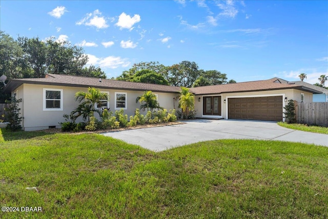 single story home with a garage and a front yard