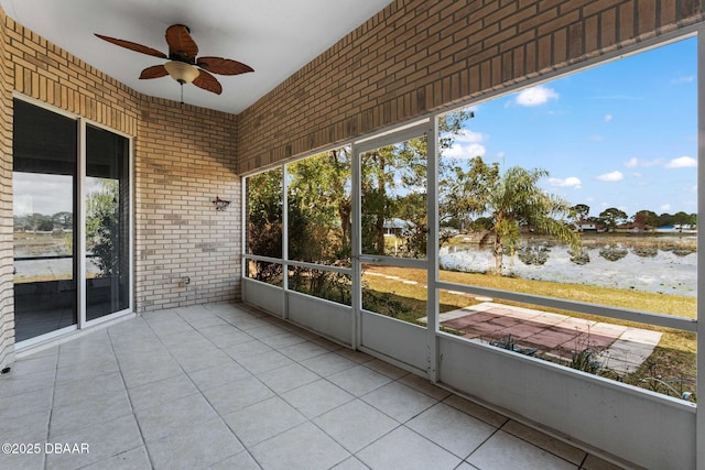 unfurnished sunroom featuring ceiling fan