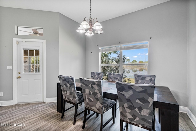 dining room with a notable chandelier, hardwood / wood-style flooring, and plenty of natural light