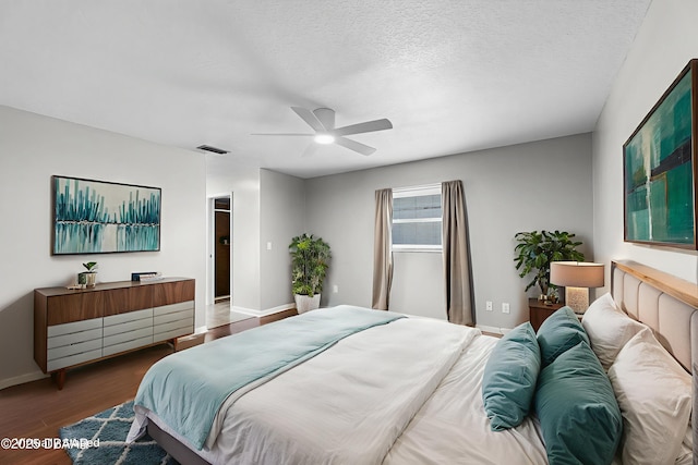 59 Blakeport Ln, Palm Coast, FL 32137 - bedroom with wood finished floors, ceiling fan, and a textured ceiling