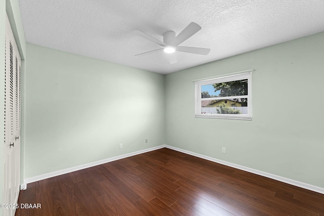 59 Blakeport Ln, Palm Coast, FL 32137 - unfurnished bedroom with a closet, dark wood finished floors, a textured ceiling, and ceiling fan