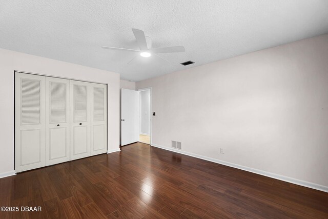 59 Blakeport Ln, Palm Coast, FL 32137 - unfurnished bedroom with wood finished floors, a closet, a textured ceiling, and ceiling fan