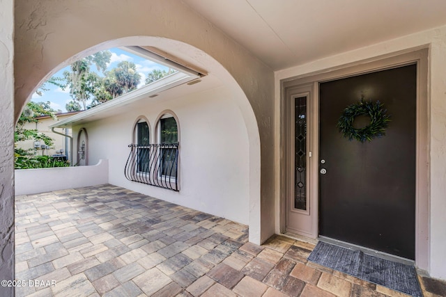 59 Blakeport Ln, Palm Coast, FL 32137 - doorway to property featuring stucco siding