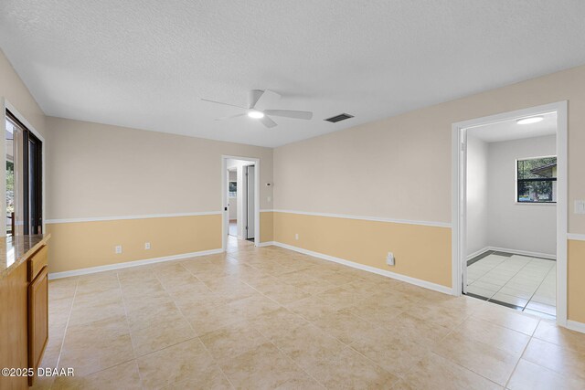 59 Blakeport Ln, Palm Coast, FL 32137 - unfurnished room with light tile patterned floors, ceiling fan, and a textured ceiling