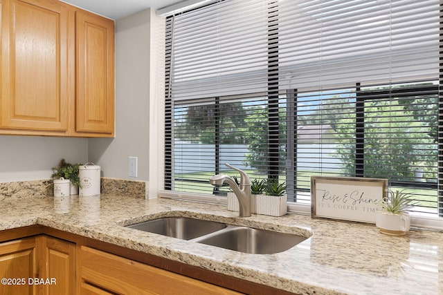 59 Blakeport Ln, Palm Coast, FL 32137 - kitchen featuring light stone counters and light brown cabinets