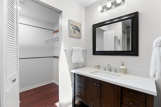 59 Blakeport Ln, Palm Coast, FL 32137 - full bath featuring vanity, wood finished floors, and a textured ceiling