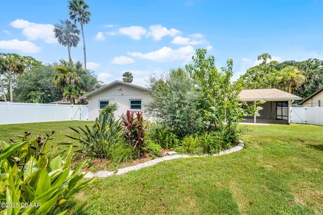 59 Blakeport Ln, Palm Coast, FL 32137 - fenced backyard with a sunroom and a gate
