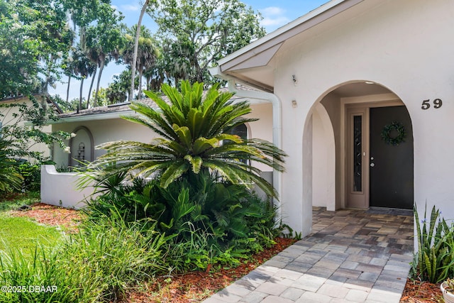 59 Blakeport Ln, Palm Coast, FL 32137 - doorway to property featuring stucco siding