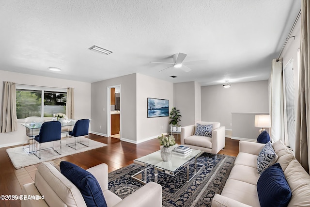 59 Blakeport Ln, Palm Coast, FL 32137 - living room featuring dark wood finished floors, a ceiling fan, and a textured ceiling