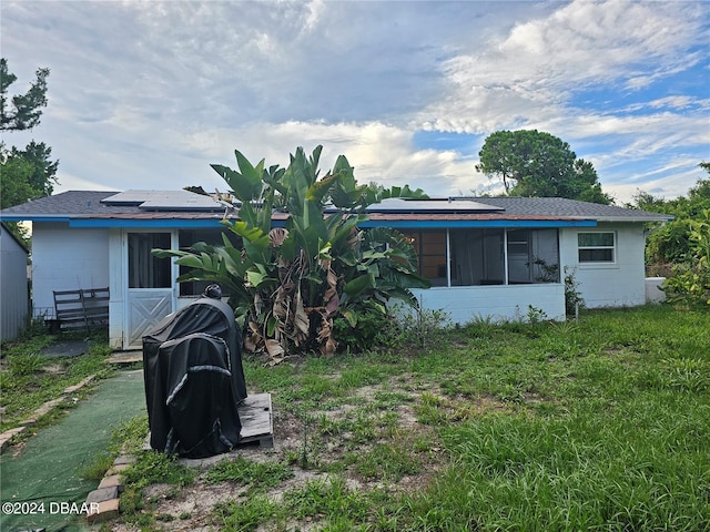 rear view of house with solar panels