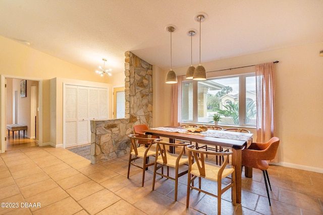 dining room with lofted ceiling and a chandelier