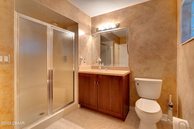 bathroom featuring toilet, vanity, tile patterned floors, and a shower with shower door