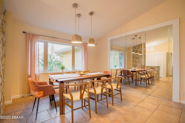 dining space featuring lofted ceiling