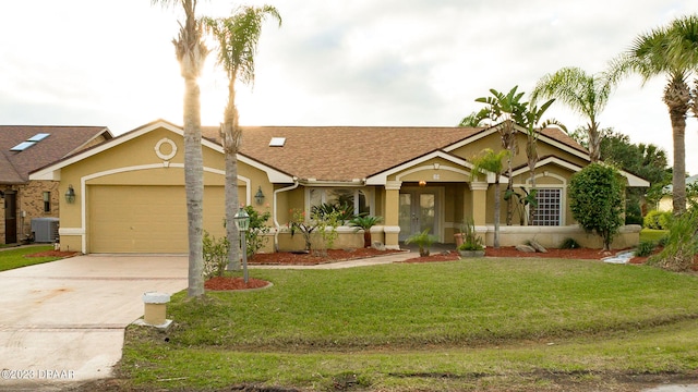 view of front of property with central air condition unit, a garage, and a front yard