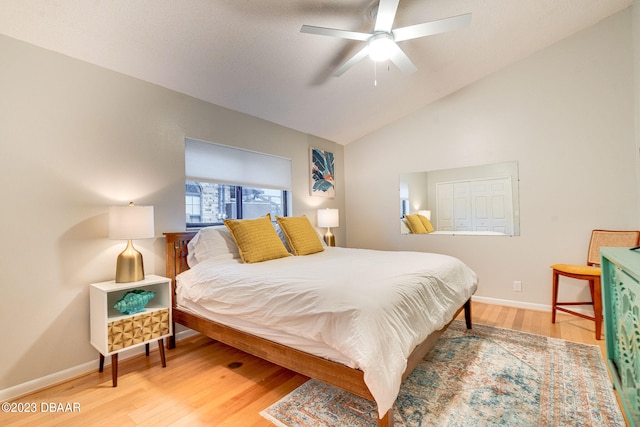 bedroom featuring ceiling fan, wood-type flooring, and vaulted ceiling