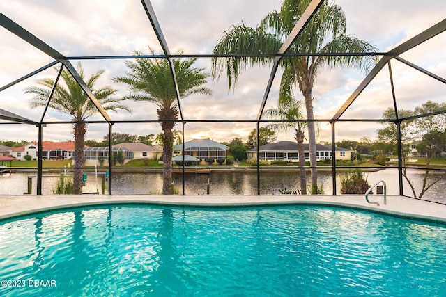 view of pool featuring a water view and glass enclosure