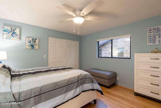 bedroom featuring a closet, light wood-type flooring, and ceiling fan