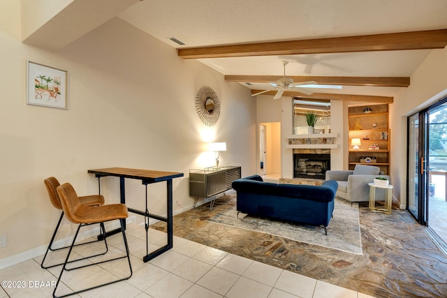 living room featuring ceiling fan, vaulted ceiling with beams, and built in shelves