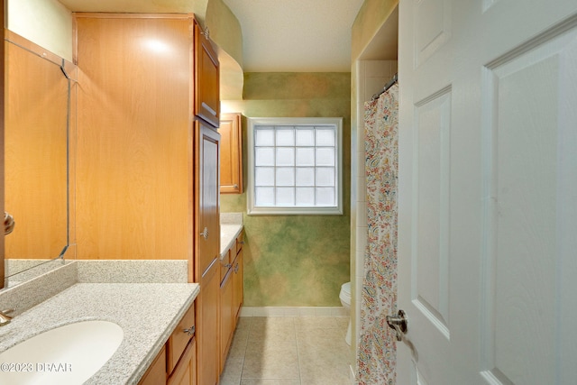 bathroom featuring toilet, vanity, and tile patterned flooring