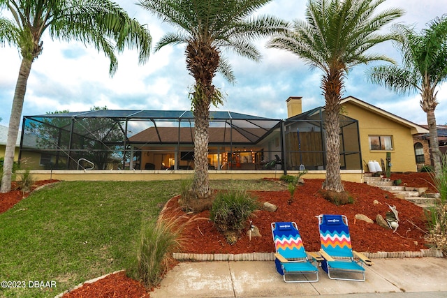 exterior space featuring a lanai, a lawn, and a patio