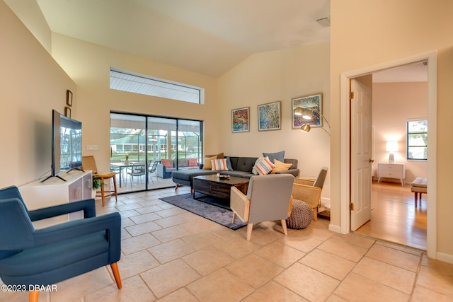 living room featuring high vaulted ceiling