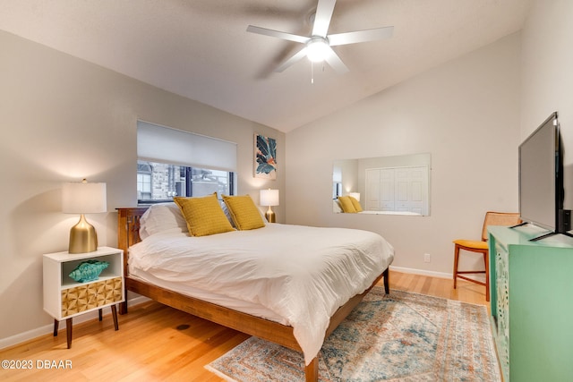 bedroom with hardwood / wood-style floors, lofted ceiling, and ceiling fan