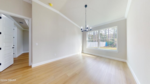 unfurnished dining area featuring crown molding, wood-type flooring, vaulted ceiling, and a notable chandelier