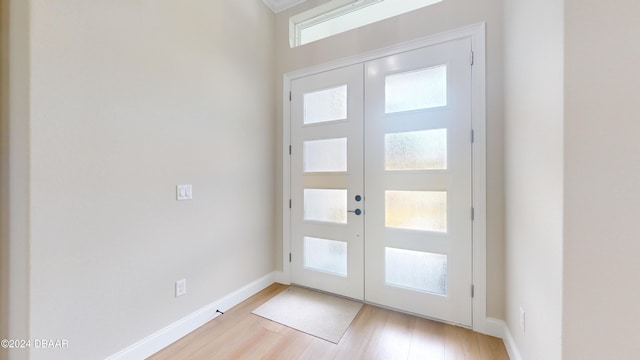 entryway with french doors, light wood-type flooring, and a healthy amount of sunlight