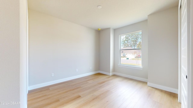 unfurnished room with light hardwood / wood-style floors