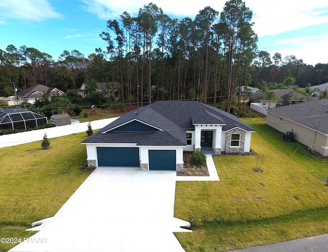 view of front of house featuring a garage and a front lawn