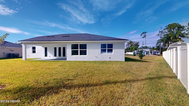 back of house with a yard and french doors