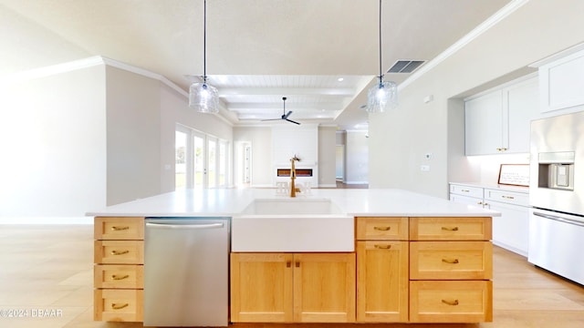 kitchen featuring ceiling fan, sink, stainless steel appliances, a center island with sink, and white cabinets