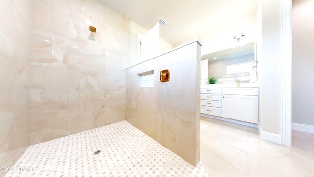 bathroom featuring vanity and tiled shower