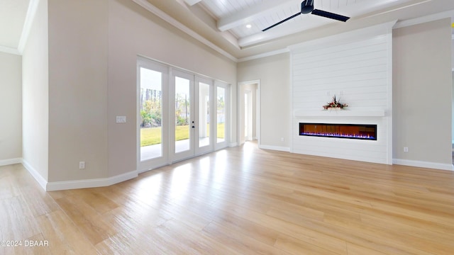 unfurnished living room with a large fireplace, light hardwood / wood-style flooring, ceiling fan, and wood ceiling