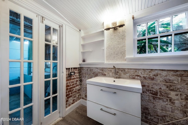 bathroom featuring wood ceiling, vanity, wood-type flooring, and brick wall